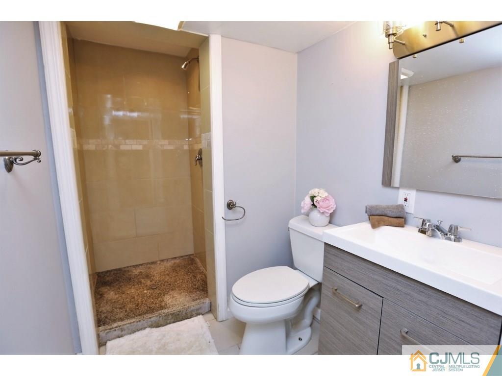 173 McFarlane Road Colonia, NJ 07067 - Photo 21 of 25 a bathroom with a sink a toilet and shower