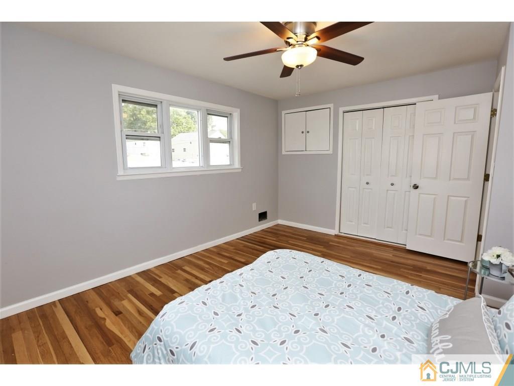 173 McFarlane Road Colonia, NJ 07067 - Photo 23 of 25 a bedroom with a bed and a painting on the wall