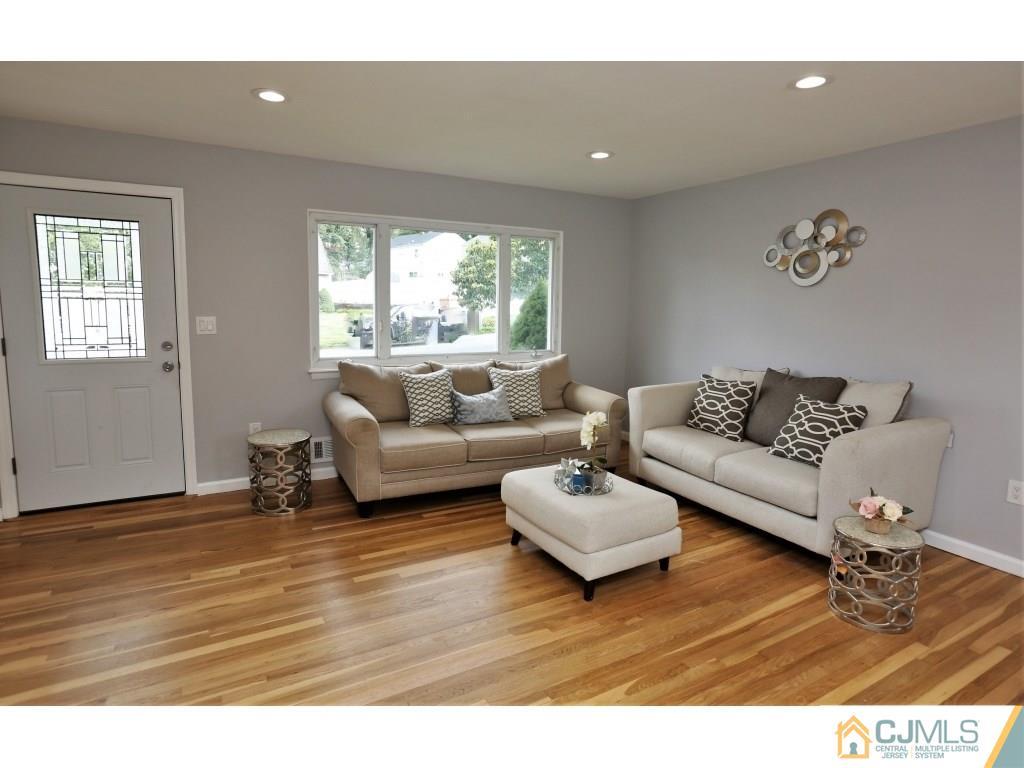 173 McFarlane Road Colonia, NJ 07067 - Photo 6 of 25 a living room with furniture and a wooden floor