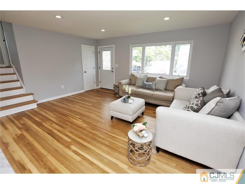 173 McFarlane Road Colonia, NJ 07067 - Photo 8 of 25 a living room with furniture and a large window