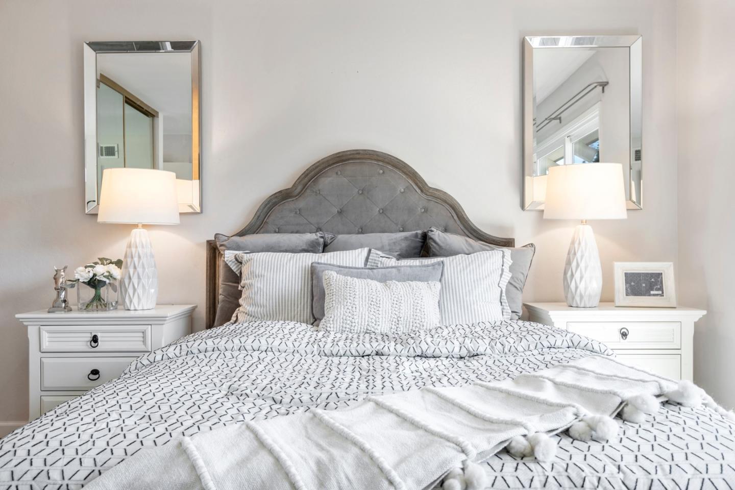 20173 Northcrest Square Cupertino, CA 95014 - Photo 19 of 29 a bedroom with a bed and a lamp on dresser