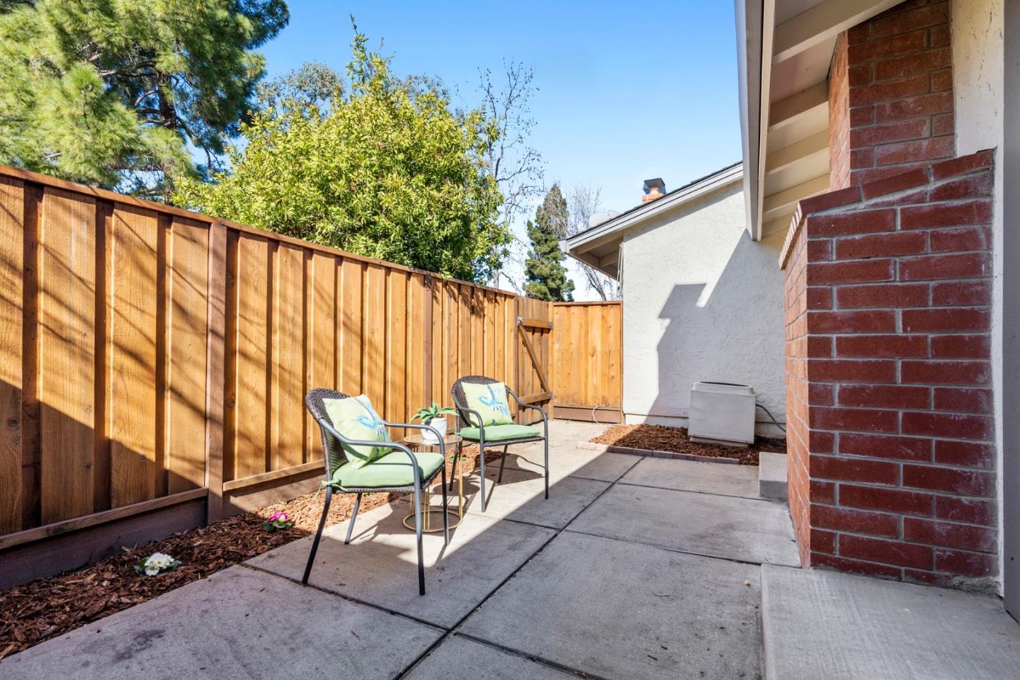 20173 Northcrest Square Cupertino, CA 95014 - Photo 23 of 29 a view of chairs and table in the back yard of the house