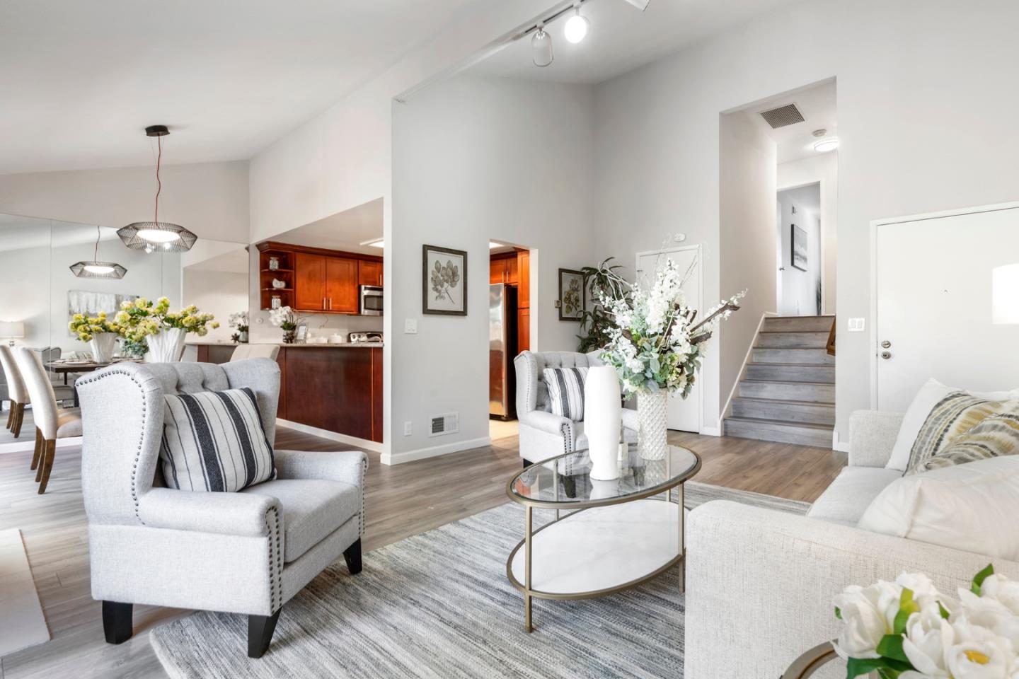 20173 Northcrest Square Cupertino, CA 95014 - Photo 4 of 29 a living room with furniture kitchen view and a chandelier