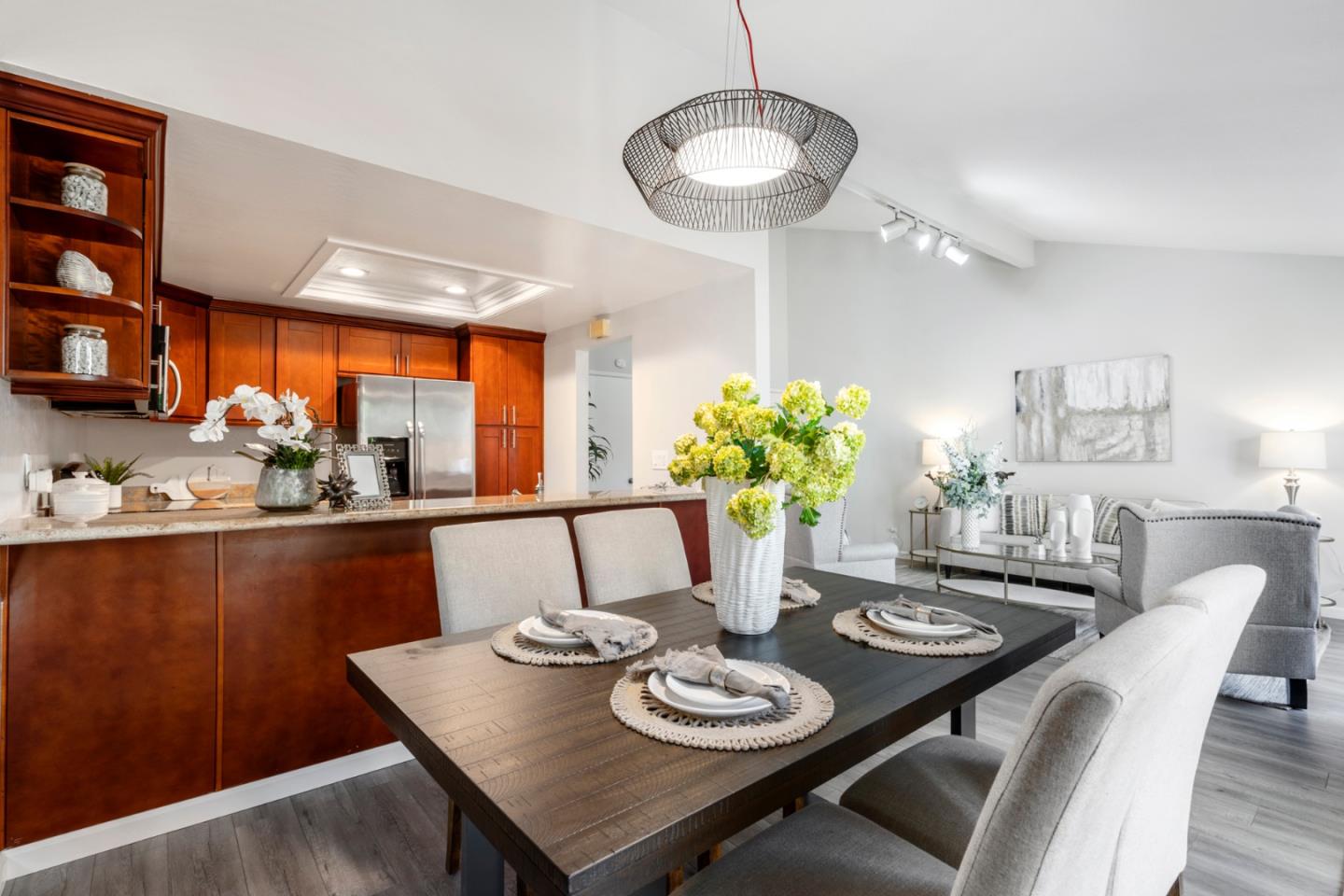 20173 Northcrest Square Cupertino, CA 95014 - Photo 9 of 29 a view of a dining room with furniture a potted plant and wooden floor