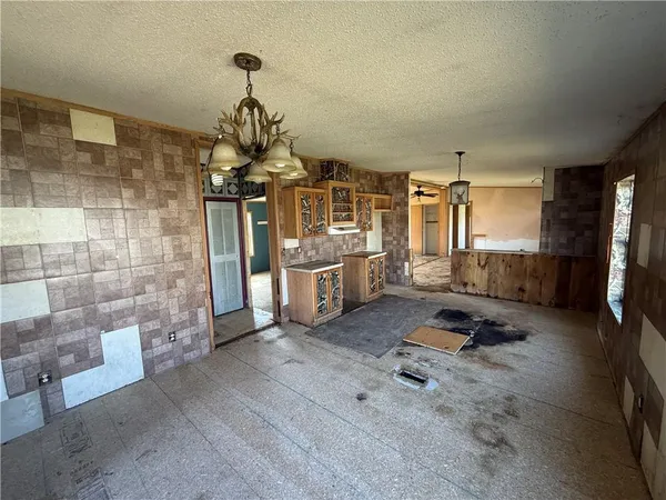 a room with gym equipment and view of living room