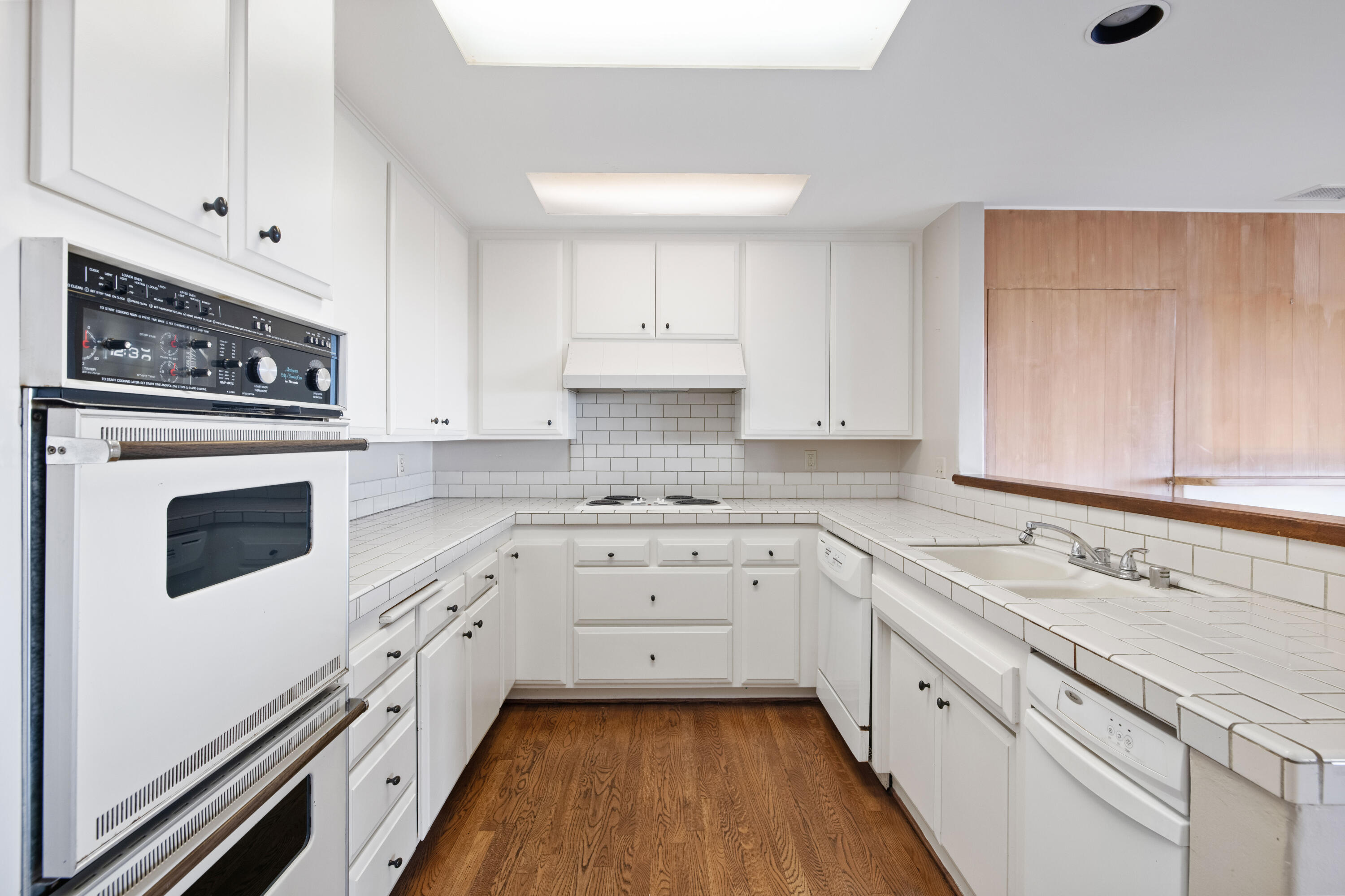 1986 Arriba Street Carpinteria, CA 93013 - Photo 11 of 25 a kitchen with granite countertop white cabinets and white appliances