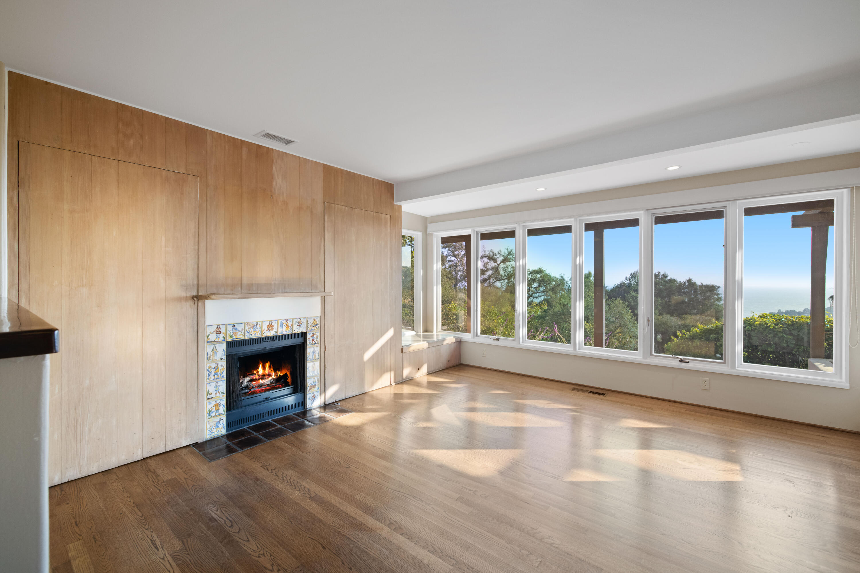1986 Arriba Street Carpinteria, CA 93013 - Photo 13 of 25 a view of empty room with wooden floor and fireplace