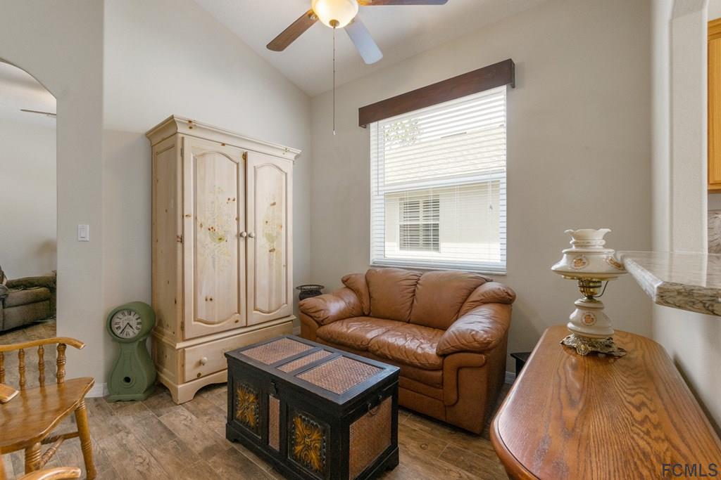 16 Raintree Circle Palm Coast, FL 32164 - Photo 11 of 45 a living room with furniture a window and a chandelier