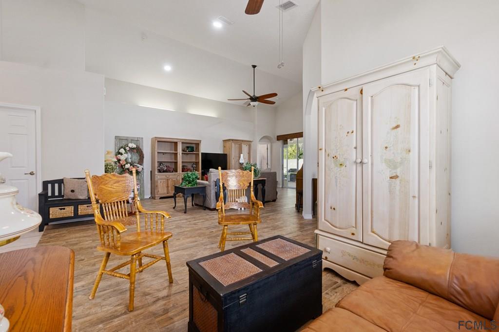 16 Raintree Circle Palm Coast, FL 32164 - Photo 12 of 45 a living room with furniture a table and chairs