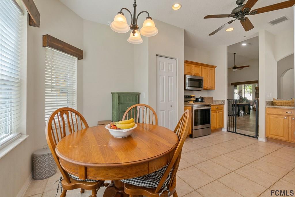 16 Raintree Circle Palm Coast, FL 32164 - Photo 15 of 45 a dining room filled chandelier and kitchen view
