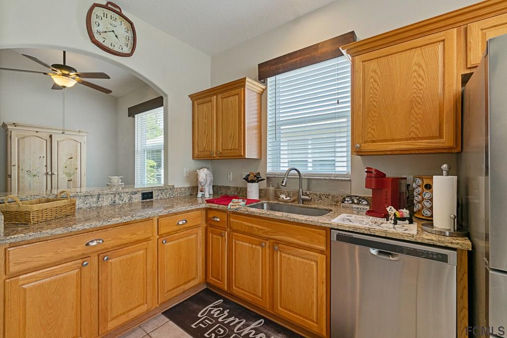 16 Raintree Circle Palm Coast, FL 32164 - Photo 16 of 45 a kitchen with stainless steel appliances a sink stove and cabinets