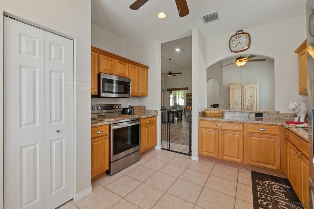 16 Raintree Circle Palm Coast, FL 32164 - Photo 17 of 45 a kitchen with cabinets and stainless steel appliances