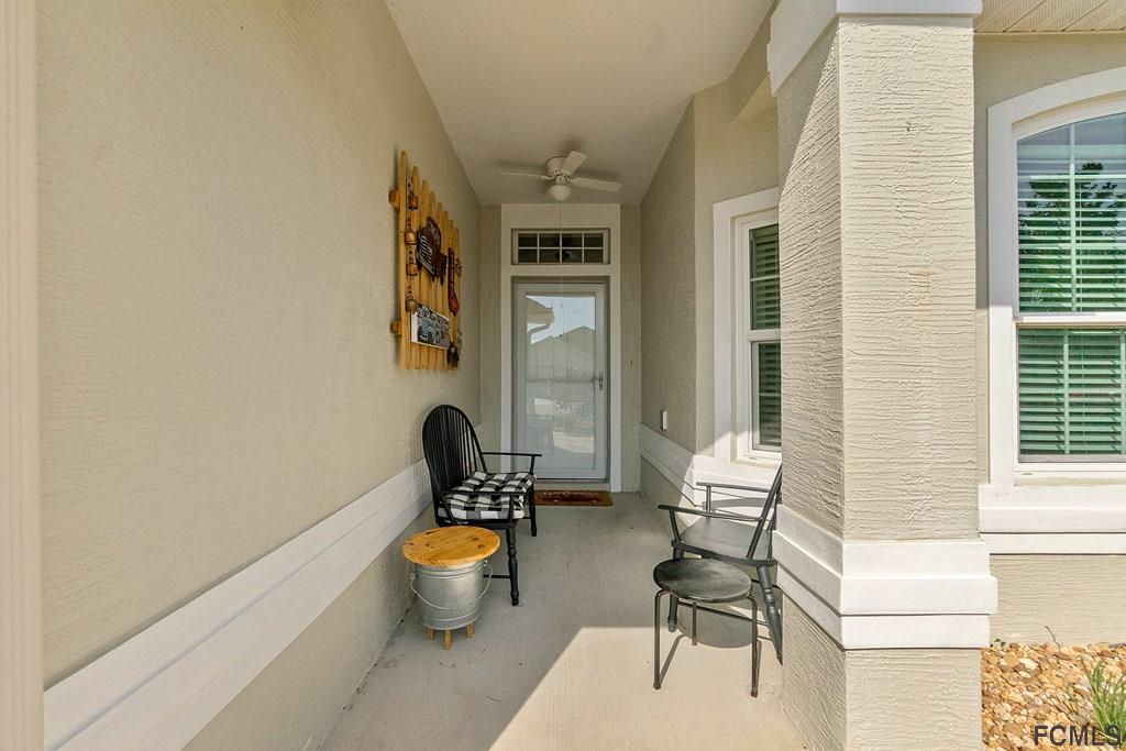 16 Raintree Circle Palm Coast, FL 32164 - Photo 2 of 45 a living room with furniture and a potted plant