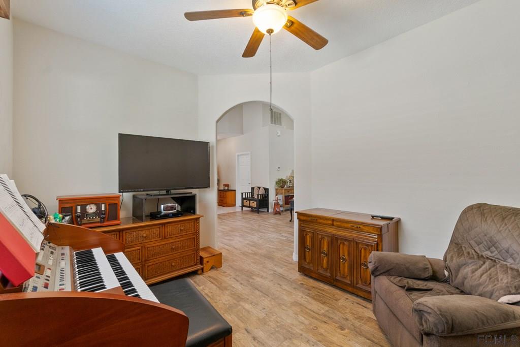 16 Raintree Circle Palm Coast, FL 32164 - Photo 21 of 45 a living room with furniture and a flat screen tv