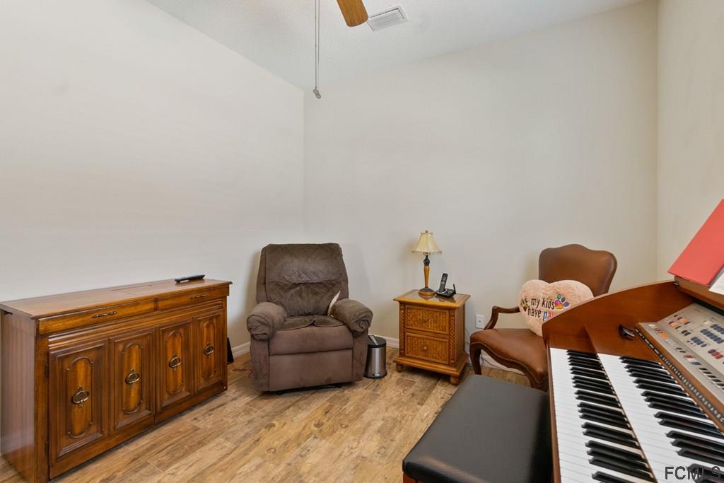 16 Raintree Circle Palm Coast, FL 32164 - Photo 22 of 45 a living room with furniture and a piano