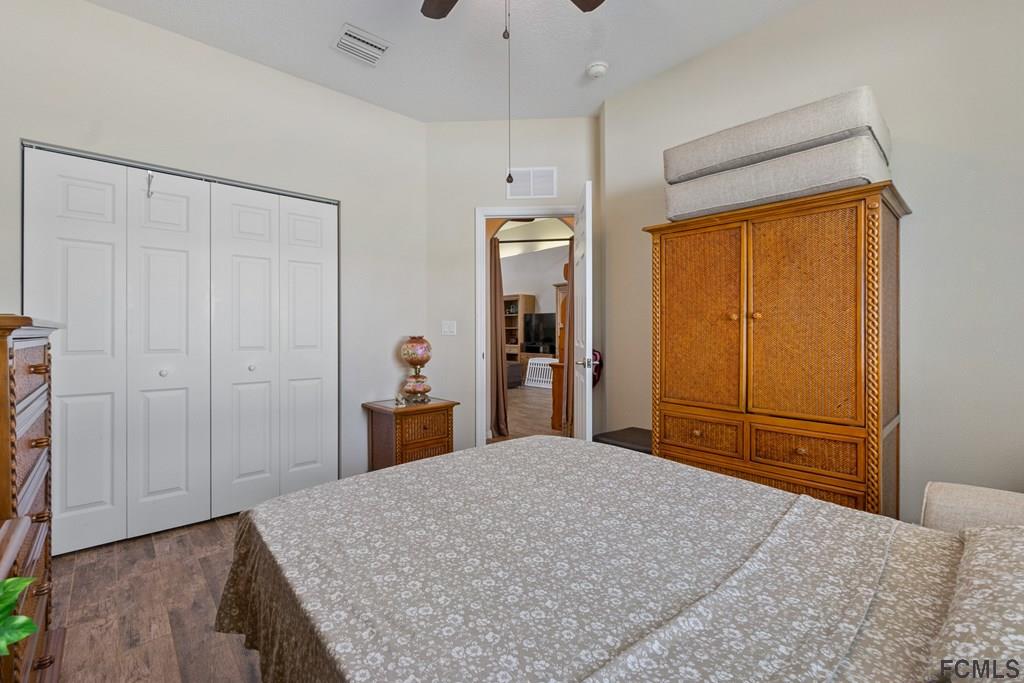 16 Raintree Circle Palm Coast, FL 32164 - Photo 23 of 45 a bedroom with a bed and a dresser