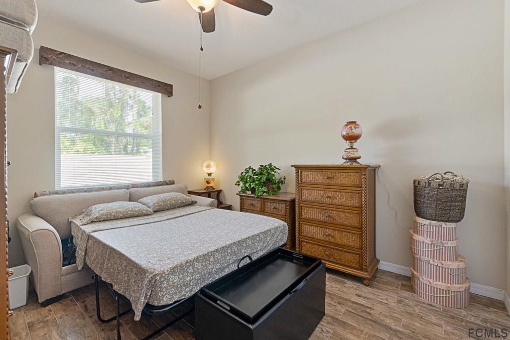 16 Raintree Circle Palm Coast, FL 32164 - Photo 24 of 45 a bedroom with a bed and wooden floor