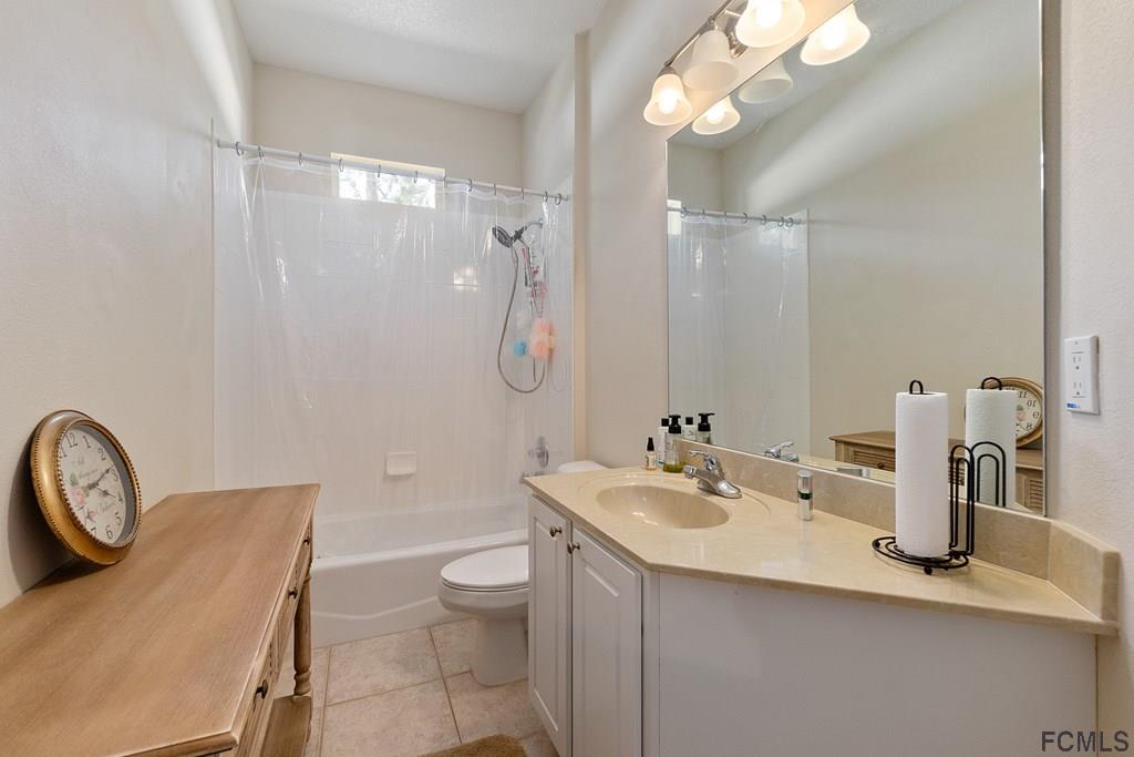 16 Raintree Circle Palm Coast, FL 32164 - Photo 25 of 45 a bathroom with a sink a toilet and a mirror