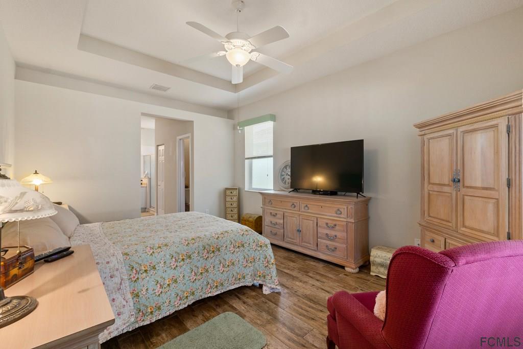 16 Raintree Circle Palm Coast, FL 32164 - Photo 26 of 45 a bedroom with a bed and a flat screen tv