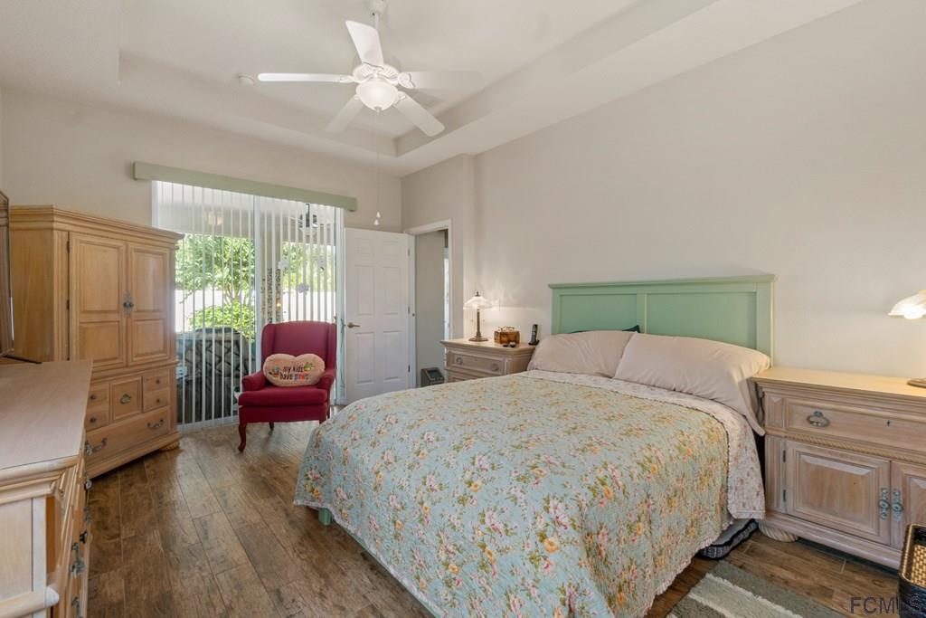 16 Raintree Circle Palm Coast, FL 32164 - Photo 28 of 45 a bedroom with a bed wooden floor and window