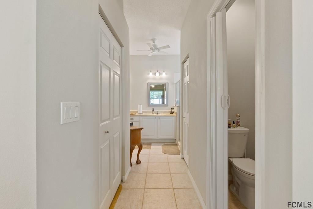 16 Raintree Circle Palm Coast, FL 32164 - Photo 29 of 45 a view of a hallway with a livingroom and a bathroom with a sink