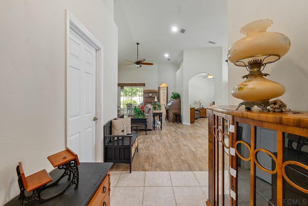 16 Raintree Circle Palm Coast, FL 32164 - Photo 3 of 45 a living room with furniture and a mirror