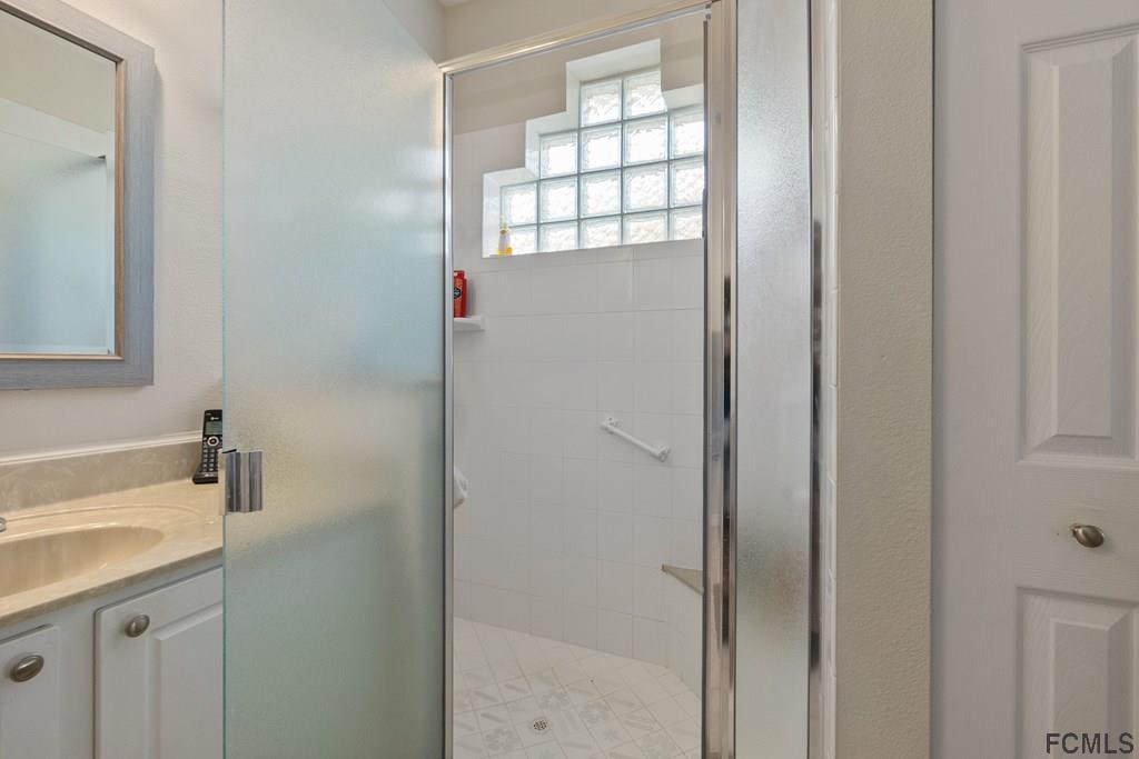 16 Raintree Circle Palm Coast, FL 32164 - Photo 31 of 45 a bathroom with a sink a toilet and shower
