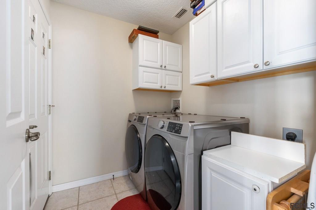 16 Raintree Circle Palm Coast, FL 32164 - Photo 33 of 45 a utility room with dryer and washer