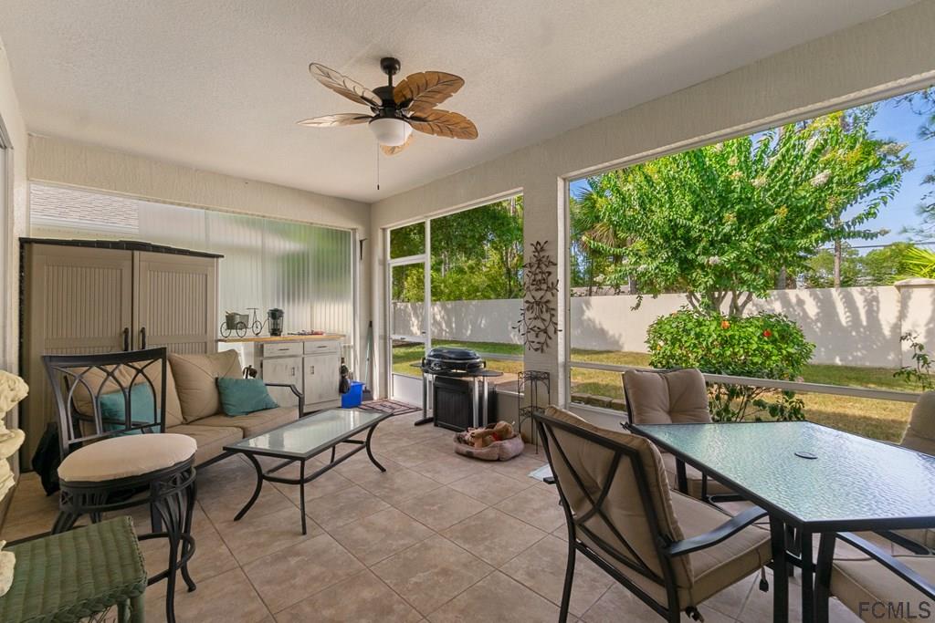 16 Raintree Circle Palm Coast, FL 32164 - Photo 34 of 45 a living room with furniture and a large window