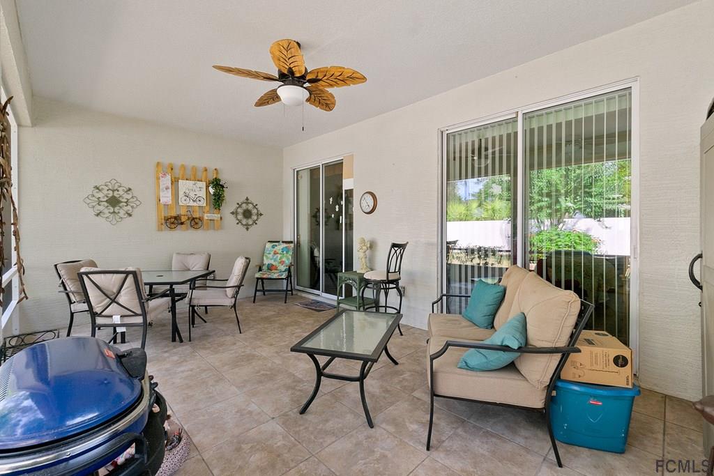 16 Raintree Circle Palm Coast, FL 32164 - Photo 36 of 45 a living room with furniture and a large window