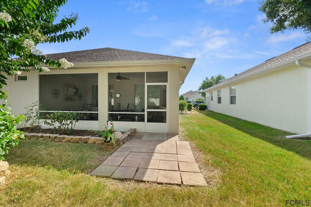 16 Raintree Circle Palm Coast, FL 32164 - Photo 38 of 45 a front view of a house with garden