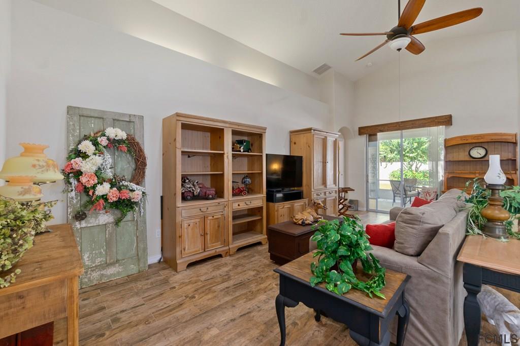16 Raintree Circle Palm Coast, FL 32164 - Photo 5 of 45 a living room with furniture and a potted plant