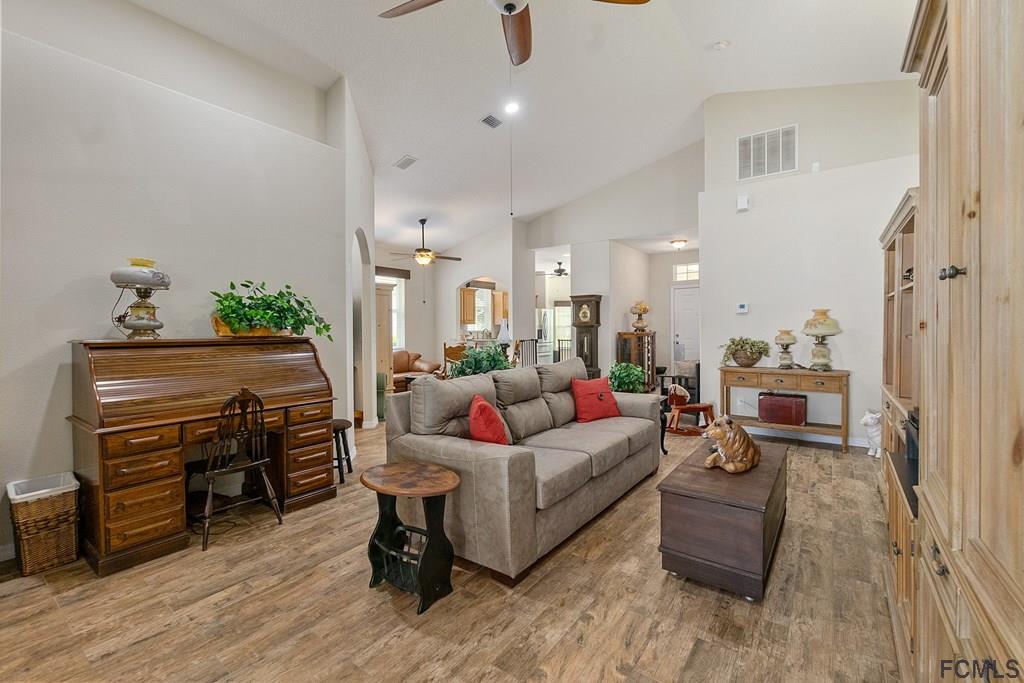 16 Raintree Circle Palm Coast, FL 32164 - Photo 7 of 45 a living room with furniture and a wooden floor