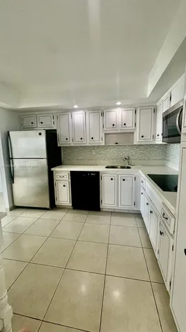 a kitchen with stainless steel appliances a stove a sink and a refrigerator