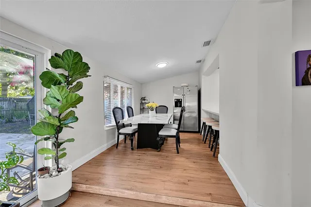 a view of a dining room with furniture window and wooden floor