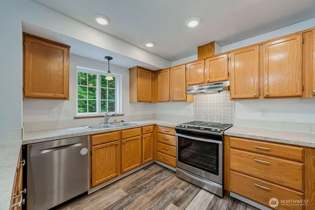 a kitchen with a sink stove and cabinets