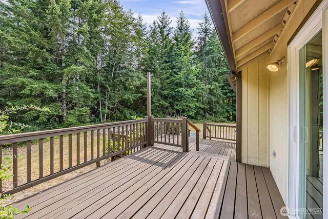 a view of balcony with wooden floor and fence