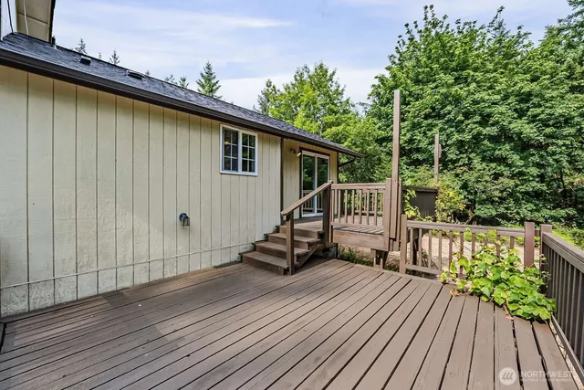 a view of a wooden deck front of house