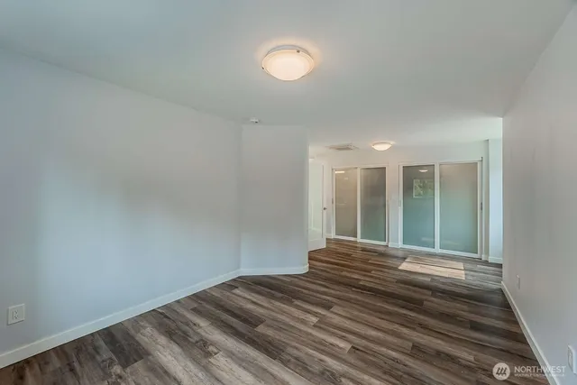 a view of a room with wooden floor and window