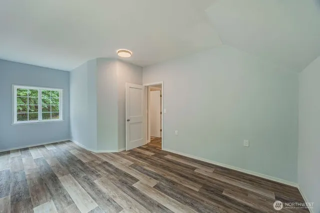 a view of room with window and hardwood floor