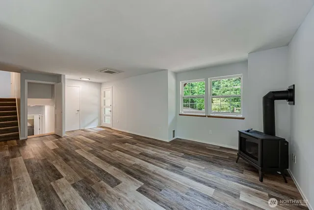 a view of a room with wooden floor and a window