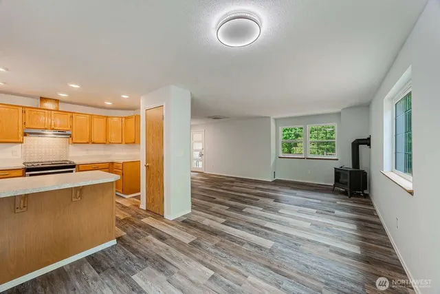 a view of kitchen with stainless steel appliances granite countertop a stove top oven