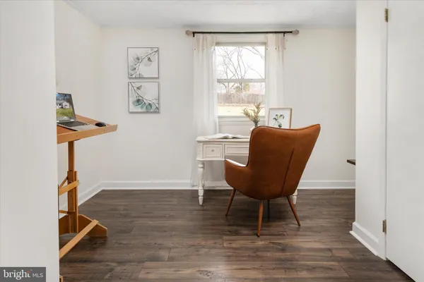 a living room with furniture a window and a flat screen tv