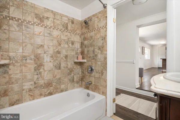 a bathroom with a bathtub and a sink
