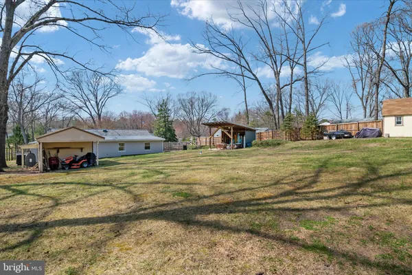 a view of a yard with a house and a tree