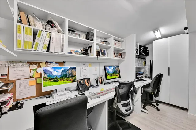 a view of a room with workspace and a window