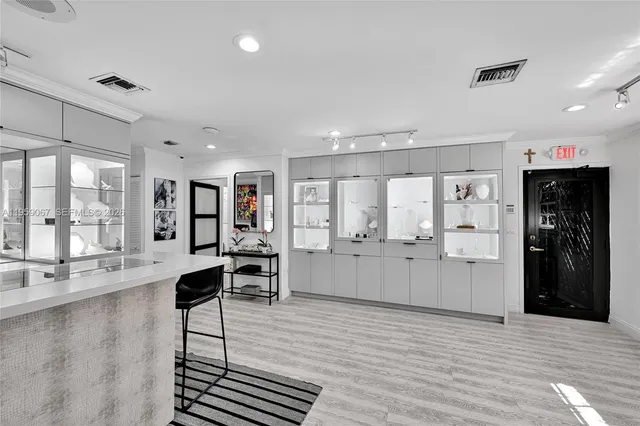 a large living room with stainless steel appliances kitchen island granite countertop furniture and a large window