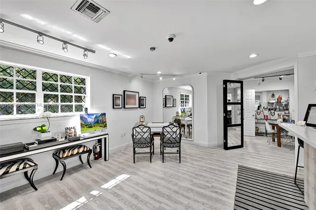 a living room with furniture a window and wooden floor