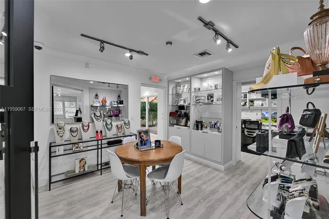 a kitchen with a sink and chairs
