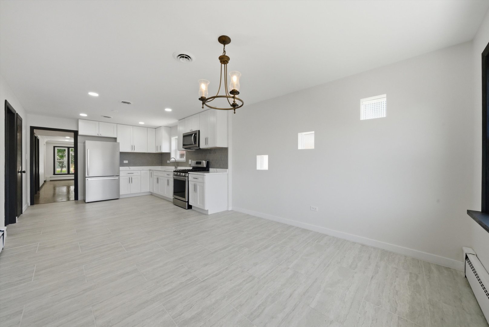3907 West Marquette Road Chicago, IL 60629 - Photo 9 of 32 a view of kitchen with wooden floor and window